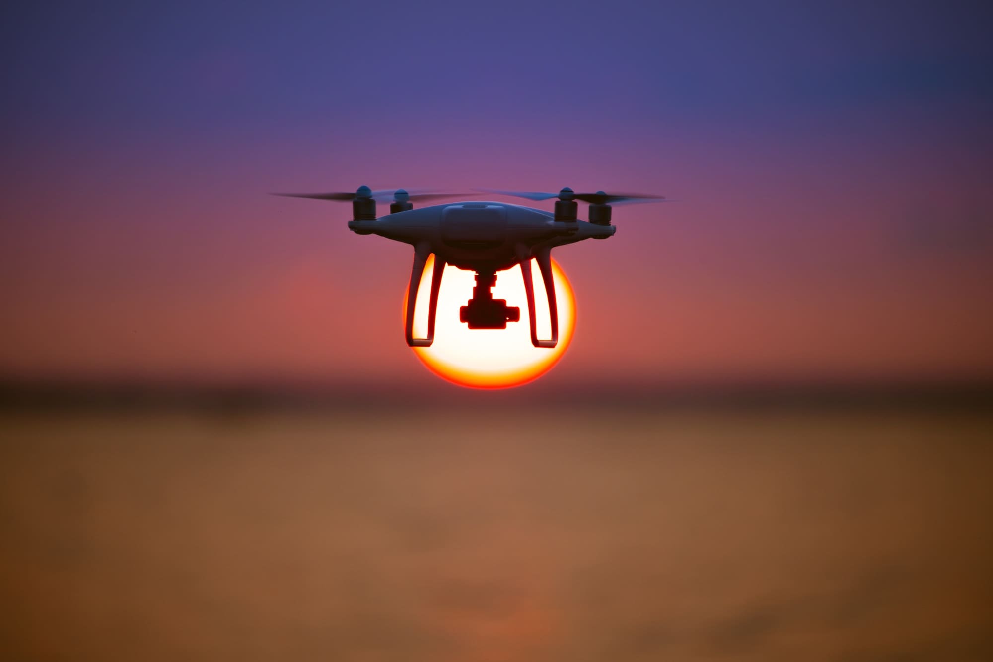 The drone flighting on the sunrise background